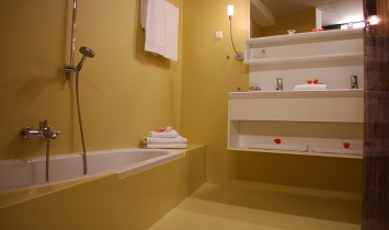 Bathroom with bath and wash basin in one of the Design apartments