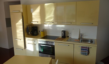 Neatly arranged Design kitchen with electric oven, ceramic stove, refrigerator, dishwasher, coffee machine, kettle and crockery and utensils for up to 8 people